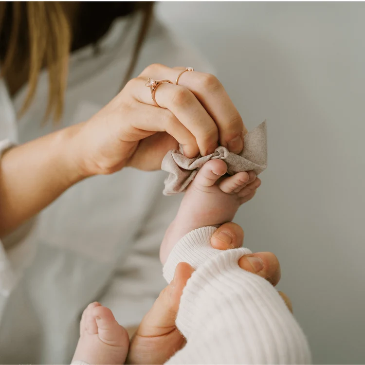 Wipe baby's hand or foot
